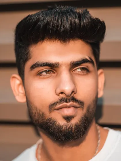 This tight headshot captures the model's features in warm, natural light. It's a clean and classic portrait that showcases his potential for commercial and print work.