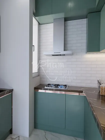 This kitchen design was inspired by my client's love for subtle green. We created a highly functional space with custom cabinetry that feels both trendy and timeless, complete with a classic white brick-style backsplash.