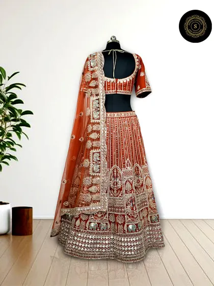 This rust-orange lehenga with intricate silver gota patti work is a unique and beautiful choice for a day wedding or Anand Karaj ceremony.