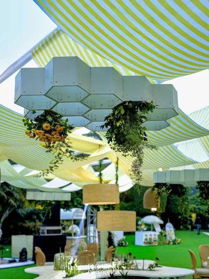 We designed and fabricated these unique honeycomb-shaped light fixtures that floated above the tables. Dripping with fresh greenery and flowers, they were a central design element that perfectly matched the bee theme.