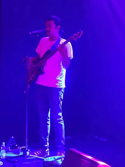 Our bassist performing under the stage lights. This shot highlights the concert-quality production we bring to corporate events.