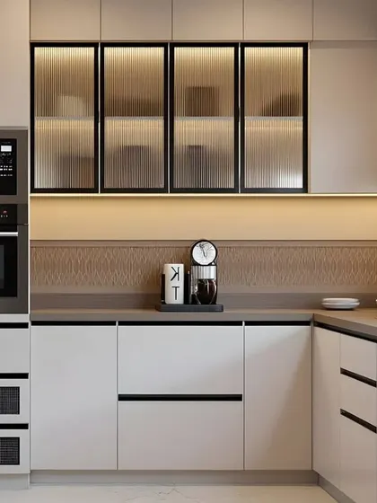 A closer look at the fine details of a modern kitchen. The fluted glass on the upper cabinets adds texture, while the handle-less drawers maintain a seamless and sophisticated profile.