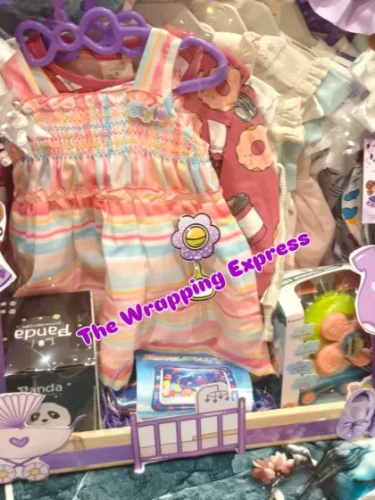 A 'Sweet Baby Girl' hamper with a purple Sofia the First theme. It's filled with colorful dresses, toys, and baby essentials, all beautifully arranged.