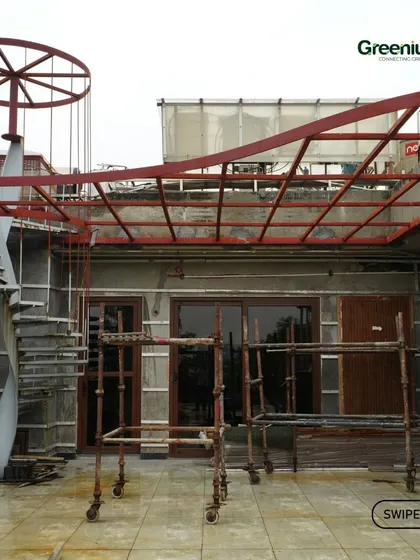 The "before" shot of a major terrace transformation. This image shows the raw space with a metal staircase and pergola frame before my team and I turned it into a beautiful, functional outdoor living area.