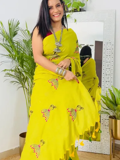 A bright and cheerful yellow khadi cotton saree with embroidered motifs. This saree is perfect for a spring or summer day and is sure to brighten your mood.