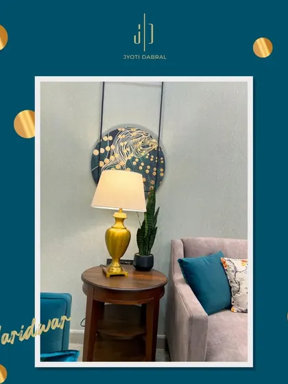 A close-up of a cozy corner in our Haridwar project. The combination of a plush sofa, a rich wooden side table, and a stylish lamp creates a warm and inviting spot to relax.