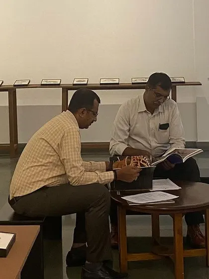 Visitors reading the artist books at the 'Quieter than Silence' exhibition by Shakuntala Kulkarni.