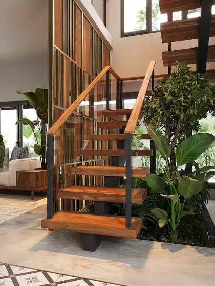 A floating staircase with wooden treads and a simple metal and wood railing, positioned next to a lush indoor garden.