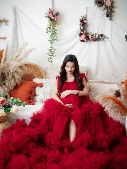 A stunning portrait of a mom-to-be in a sea of red tulle. This shot was for her gender reveal, celebrating that a baby boy is on the way.