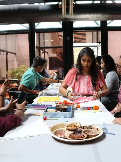 A participant at our 'Sundye' party, deeply focused on her tie-dye creation. The workshop was filled with a wonderful energy of curiosity and creativity.