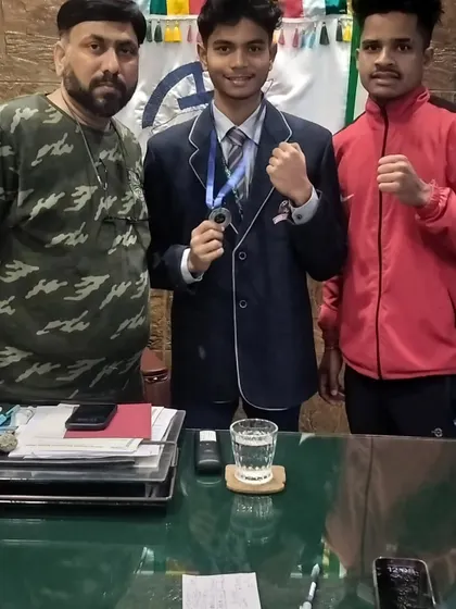Another shot of our young champion proudly displaying his medal. These victories are a testament to the discipline learned in our youth boxing program.