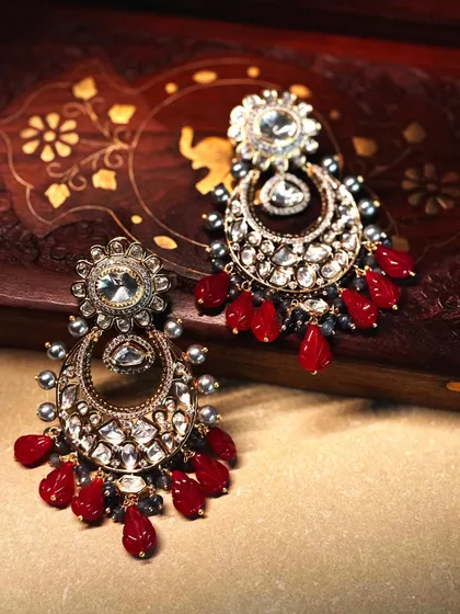 A bold and beautiful pair of chandbalis, featuring a rich combination of polki diamonds and deep red ruby drops.