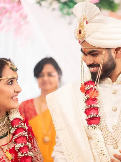 A beautiful, smiling glance exchanged between the bride and groom during their Gujarati wedding ceremony.