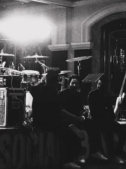 A black and white shot of the stage before the show begins. This highlights the drum kit, amps, and the professional gear we bring to every corporate gig.