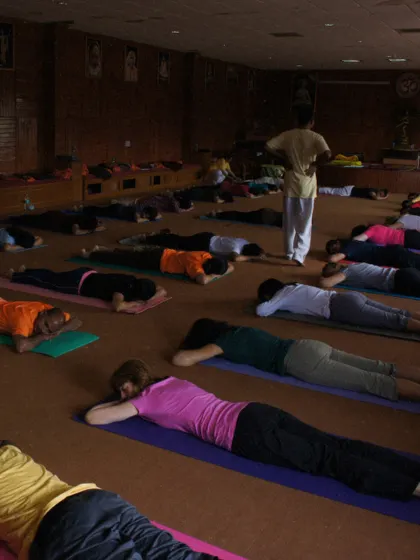 A class in Makarasana, the crocodile pose, resting between asanas. This image from a past TTC captures the discipline and collective energy of the Gurukula system.