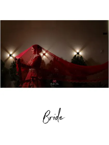 An artistic shot of the bride with her flowing red veil, creating a dramatic and beautiful silhouette.