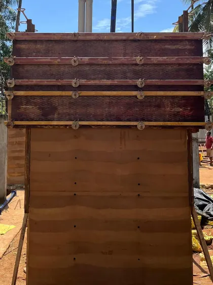 A close-up of the formwork used to create our rammed earth walls. This image shows the process of compacting layers of soil, a method that is both sustainable and results in incredibly strong, beautiful walls with natural thermal properties.