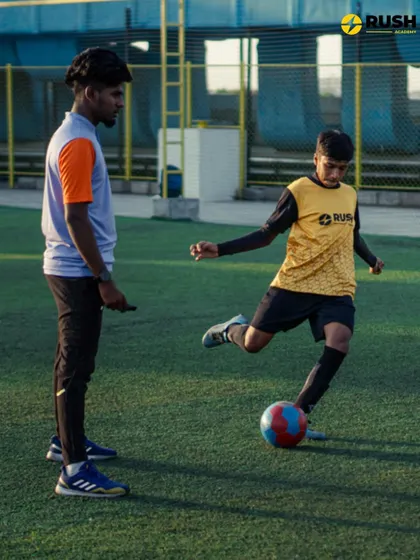 A coach provides one-on-one instruction on shooting technique. This personalized guidance helps players refine their skills effectively.