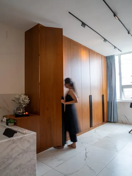 This view shows the impressive height of the custom wardrobes and a secret door panel that blends seamlessly into the design.