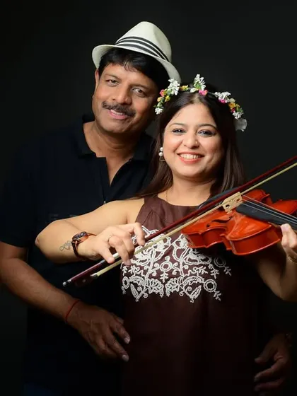 This couple brought a violin to their anniversary shoot, a wonderful personal touch that I incorporated into their portraits against a classic dark backdrop.