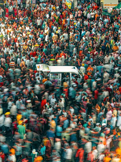An ambulance making its way through the massive crowd at the Rath Yatra. This long-exposure shot captures the motion and stillness of the moment, a river of humanity parting for a moment of urgency.