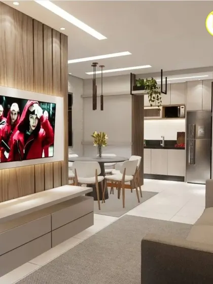 This compact living and dining space is designed for functionality. A wood-panelled TV unit defines the living area, while the adjacent dining space is simple and elegant, showing our expertise in small flat interior design.