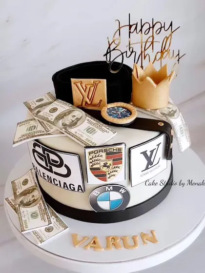 When the husband loves brands. This cake is a tribute to his favorite things, featuring logos from BMW, Porsche, and Louis Vuitton, plus a crown and edible money.