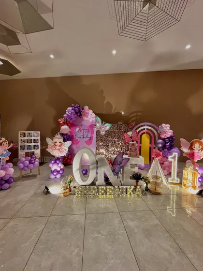 A straight-on view of the butterfly theme, showcasing the symmetry and detail in the arrangement of the props and balloons.