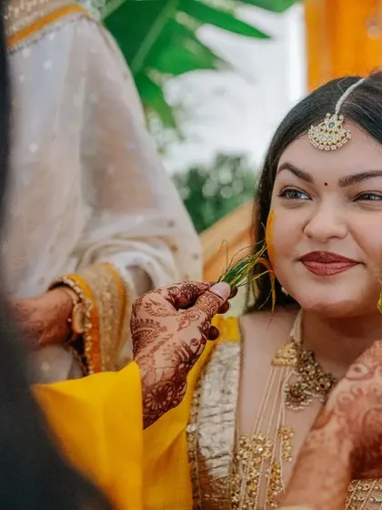 The Haldi ceremony is full of candid, joyful moments. Here, guests playfully apply turmeric to the bride and groom, and we are there to ensure the setting is as beautiful as the emotions.