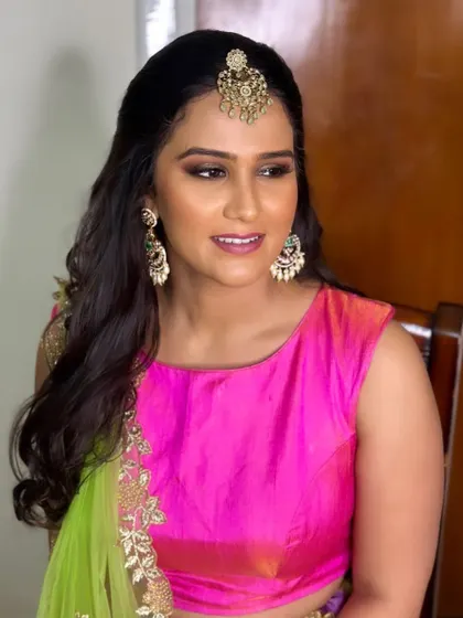 A vibrant and fun Mehendi look for my dear friend Varshini. The bright pink lip and glowing skin match the festive energy of the event.