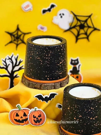 My terrazzo candle with a Halloween twist. The black jar is speckled with orange, and it sits on a natural wood slice, creating a spooky yet chic look.