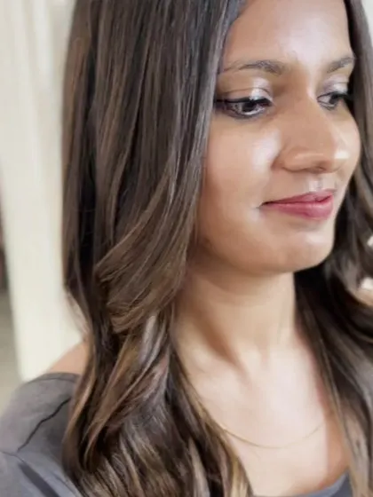 A close-up portrait of the client, with her highlighted hair framing her face beautifully.