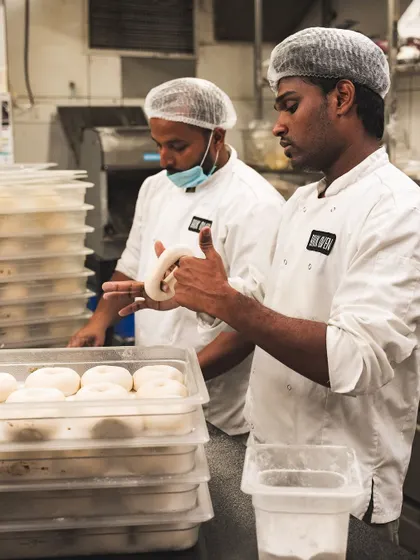 Now for the bagels. Our bakers hand-shape each bagel, a skill that ensures the classic dense and chewy texture.