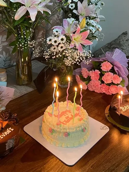 Make a wish! A beautiful scene of multiple birthday cakes lit up with candles, ready for a celebration.
