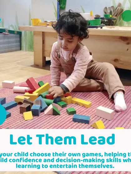 A toddler deeply engaged with building blocks. Offering open-ended toys like these allows children to lead their own play and build confidence.