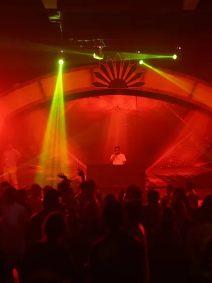 The stage is ablaze with red and yellow lights, creating a high-impact visual that matches the intensity of the music.