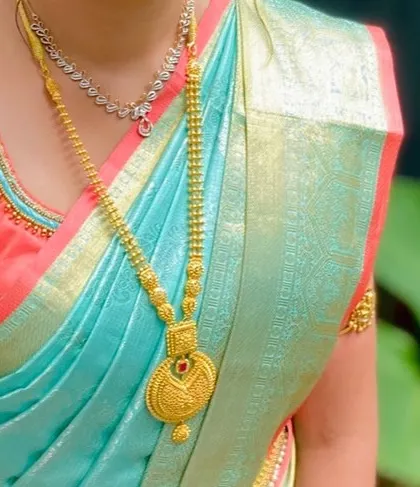 A detail shot of the client's jewellery and the perfectly draped silk saree.