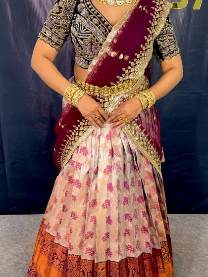 A detailed shot of the half-saree look, showing the intricate embroidery on the blouse and the way the dupatta is draped.