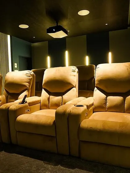 A close-up of the luxurious, mustard-colored recliners. I help clients choose fabrics and styles that match their interior design vision while prioritizing comfort and durability.