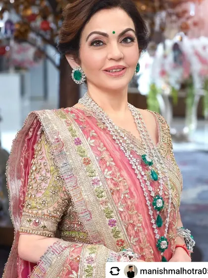 The ever gorgeous and gracious Mrs. Nita Mukesh Ambani. This close-up portrait beautifully captures her elegance and the stunning details of her jewelry and embroidered saree.