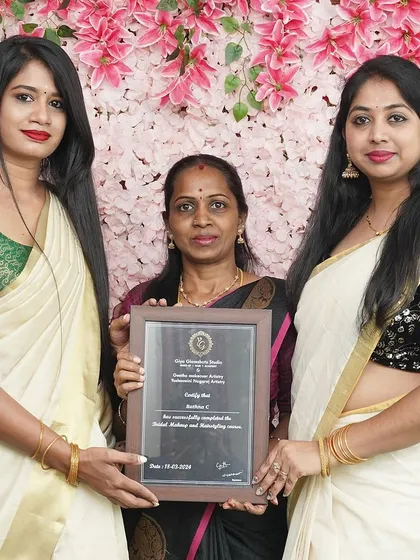 A student from Batch 12, dressed in a traditional Kerala saree, receives her certificate. My course covers diverse South-Indian bridal styles.