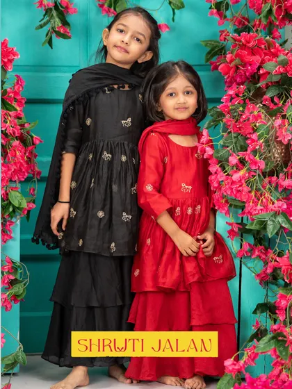 I love creating sister sets that are both bold and beautiful. This duo in matching red and black sharara sets showcases how different colors can create a stunning, coordinated look for any festive occasion.