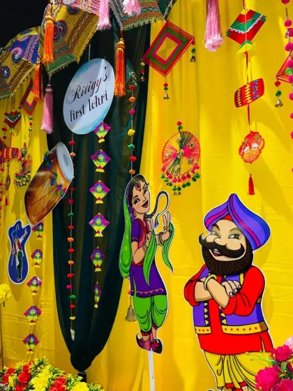I love incorporating fun, cartoonish cutouts of a Punjabi couple to add a playful touch to the traditional Lohri decor.