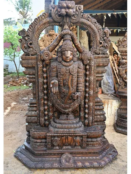 Our 79-inch standing Lord Venkatajalapathy sculpture is carved with immense devotion and detail. Finished in a classic wax brown, this statue showcases the intricate ornamentation and serene divinity characteristic of South Indian temple art.