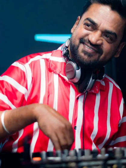 A candid shot of me mixing, with a smile that says I love what I do. Creating these moments of joy is my passion.