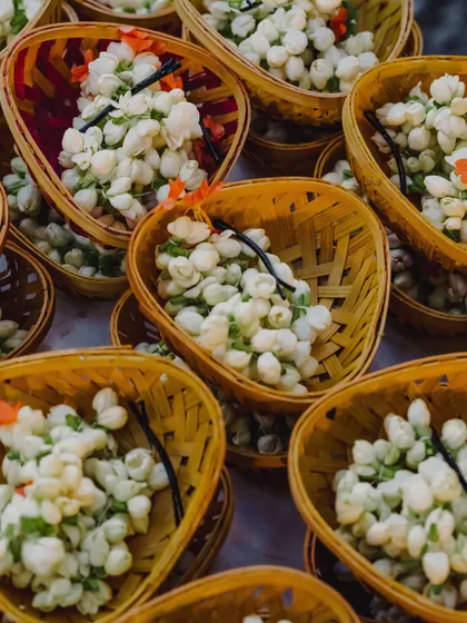 Baskets filled with fresh jasmine buds, ready to be given to guests or used in rituals. The fragrance of fresh flowers is an essential part of the sensory experience we create.
