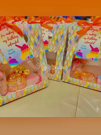 We created these fun "Pop It" themed birthday hampers for a colorful party. Each box is filled with a mix of treats and toys, reflecting the playful theme.