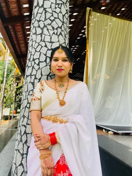 A full view of the client in her custom red and white half saree.