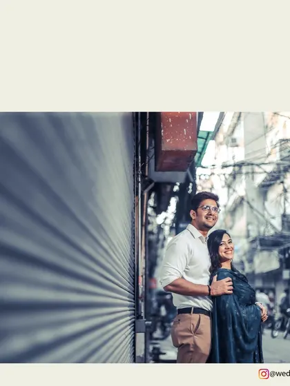 A low-angle shot from a pre-wedding session in Old Delhi, capturing the couple against the unique textures of the city.
