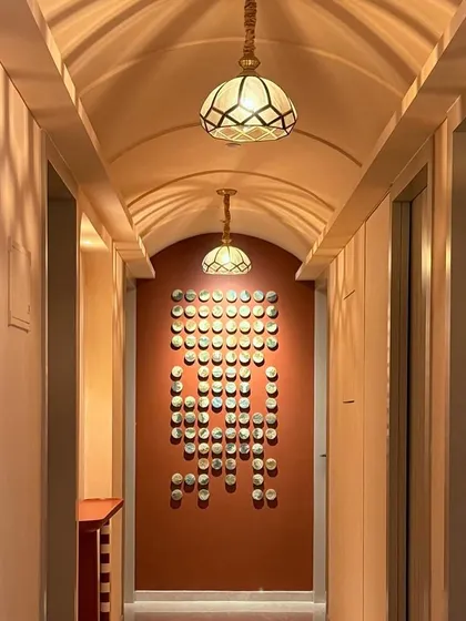 For this Mumbai residence, I created an installation of 100 miniature landscape paintings. This view shows how the entire piece transforms a long hallway into a gallery of memories.
